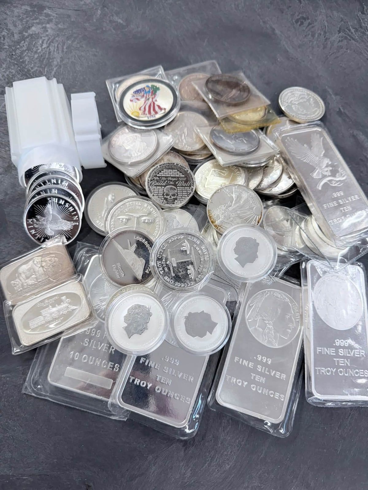 Silver bullion bars and coins, including ten-ounce .999 fine silver bars, on the counter at New Georgia Pawn